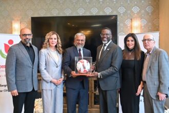 Zaman Mehdi presents a Made-in-Pakistan football to Chicago Mayor Brandon Johnson